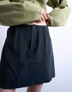 Model wearing Super soft cupro mini skirt in black