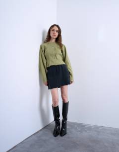 Model wearing Super soft cupro mini skirt in black