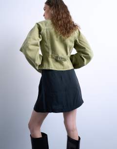 Model wearing Super soft cupro mini skirt in black