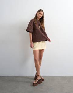 Model wearing Super soft cupro mini skirt in buttermilk