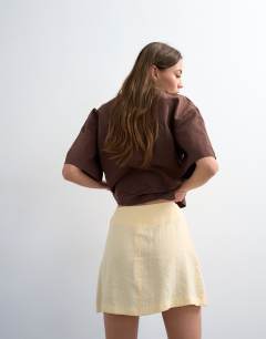 Model wearing Super soft cupro mini skirt in buttermilk