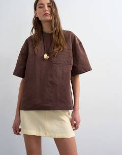 Model wearing Super soft cupro mini skirt in buttermilk