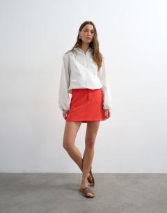 Model wearing Super soft cupro mini skirt in red