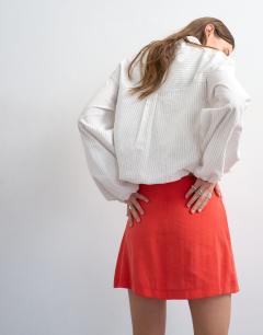 Model wearing Super soft cupro mini skirt in red