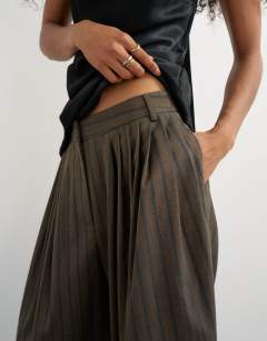 Model wearing Super wide leg trouser in chocolate stripe