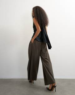 Model wearing Super wide leg trouser in chocolate stripe