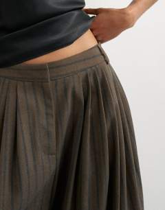 Model wearing Super wide leg trouser in chocolate stripe