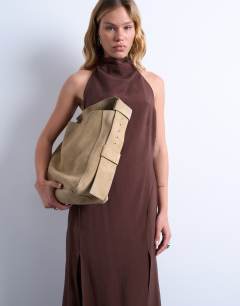 Model wearing Suri real suede leather shoulder bag in tan