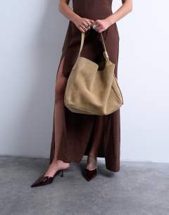 Model wearing Suri real suede leather shoulder bag in tan