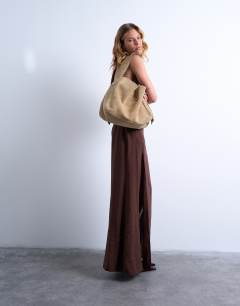 Model wearing Suri real suede leather shoulder bag in tan