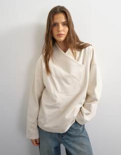 Model wearing Sweat high neck cross over jumper in stone