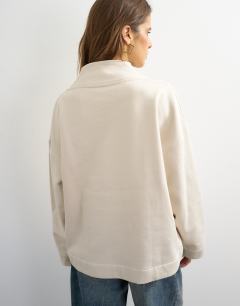 Model wearing Sweat high neck cross over jumper in stone