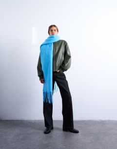 Model wearing Sydney blanket scarf in blue