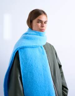 Model wearing Sydney blanket scarf in blue