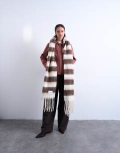 Model wearing Sydney blanket scarf in brown & white stripe