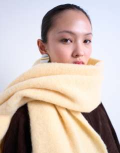 Model wearing Sydney blanket scarf in buttermilk