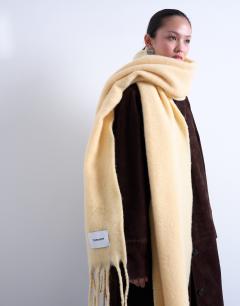 Model wearing Sydney blanket scarf in buttermilk