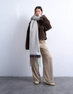 Model wearing Sydney blanket scarf in chocolate and mint