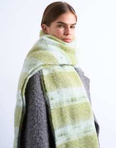 Model wearing Sydney blanket scarf in green & white stripe