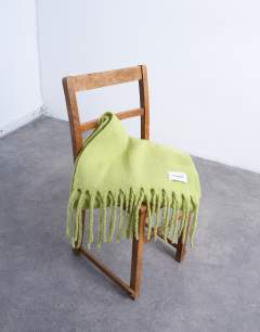Model wearing Sydney blanket scarf in green