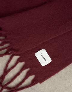 Model wearing Sydney blanket scarf in maroon