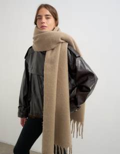 Model wearing Sydney blanket scarf in mink