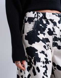 Model wearing Tab waist balloon trouser in cow print