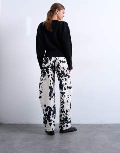 Model wearing Tab waist balloon trouser in cow print