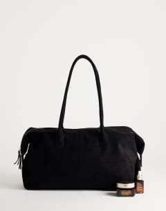 Model wearing Tabby suedette weekend bag in black weave