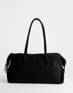 Model wearing Tabby suedette weekend bag in black weave