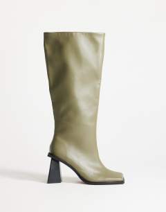 Model wearing Tabitha extended rand knee high heeled boot in green