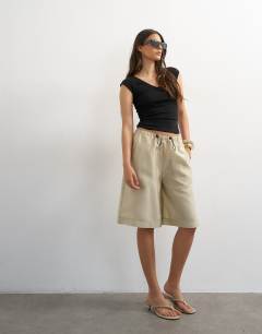 Model wearing Taffeta A line longline short in oyster