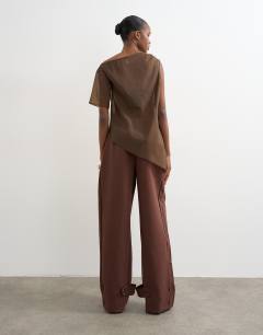Model wearing Tailored barrel leg tab detail trouser in brown