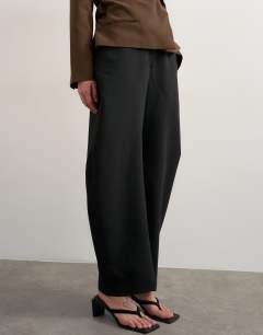 Model wearing Tailored barrel trouser in black
