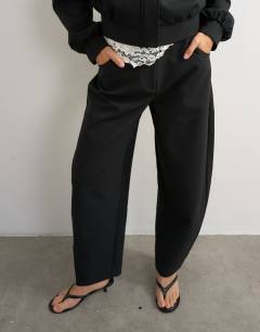 Model wearing Tailored bubble barrel leg trouser in black