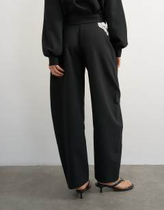 Model wearing Tailored bubble barrel leg trouser in black