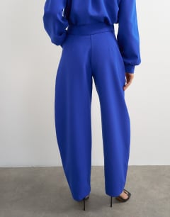 Model wearing Tailored bubble barrel leg trouser in blue