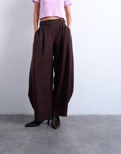 Model wearing Tailored horseshoe leg trouser in chocolate