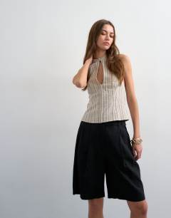 Model wearing Tailored linen ovoid bermuda shorts in black