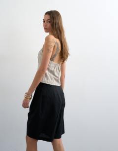 Model wearing Tailored linen ovoid bermuda shorts in black