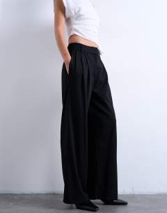 Model wearing Tailored pleated high waist trouser in black