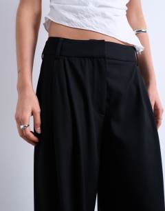 Model wearing Tailored pleated high waist trouser in black