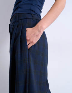 Model wearing Tailored pleated high waist trouser in check