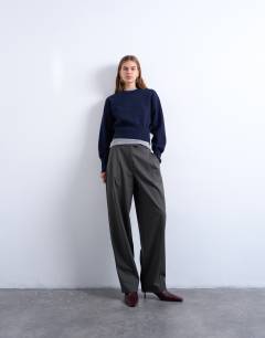 Model wearing Tailored pleated ovoid trouser in charcoal