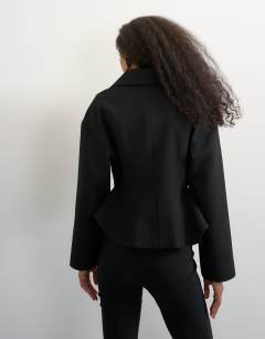 Model wearing Tailored zip through peplum top in black