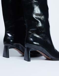 Model wearing Talia chisel toe knee high boot in black