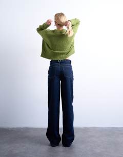 Model wearing Tall Cinch low rise relaxed jean in raw look indigo