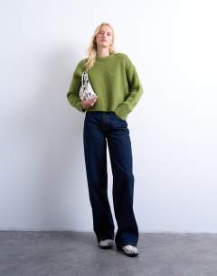 Model wearing Tall Cinch low rise relaxed jean in raw look indigo