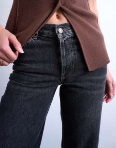 Model wearing Tall Ember low rise straight leg jean in washed black