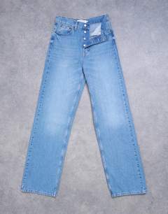 Model wearing Tall mid rise loose fit straight jean in vintage blue